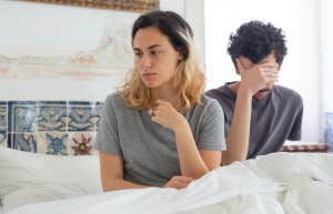 woman and man upset in bed