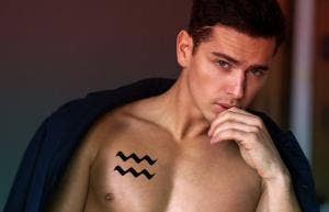 man with aquarius tattoo on chest