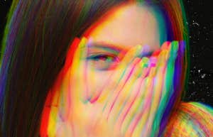woman peeking through fingers