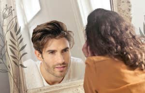Woman looking into mirror