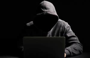 I Went Undercover On Ashley Madison To Learn Why Women Cheat anonymous man sitting in the dark on his computer