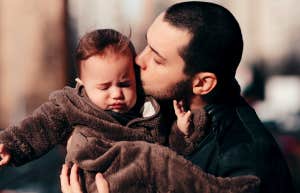 upset baby with father