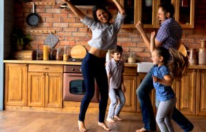happy family dancing to the best songs for mothers day