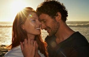 man and woman smiling on the beach