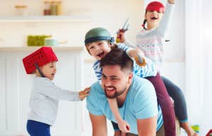 dad playing with three kids