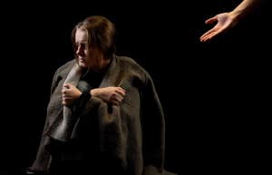 A Mother Realizes She Has To Let Her Daughter Go After She Refuses To Change Her Lifestyle woman in the dark with blanket around her and hand reaching out to her