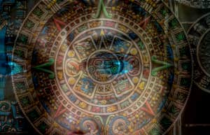 eyes peeking behind Maya calendar
