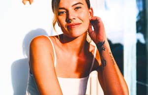 woman with tattoos looking at the camera