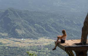 woman sitting on cliff