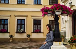 woman sitting near lamp post 