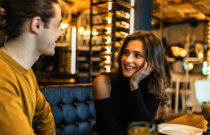 Experts Reveal The Harsh Reasons Men Might 'Disappear' After A Third Date couple chatting on dinner date