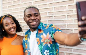 smiling couple taking selfie together