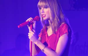 Taylor Swift performing in a red dress