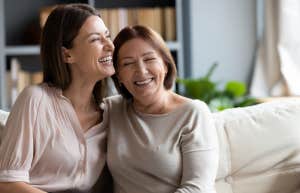 mom and adult daughter laughing together
