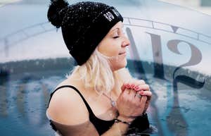 Woman taking an ice bath, focusing on breathing 