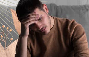Depressed man sitting on couch