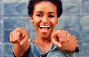 smiling woman pointing at the camera