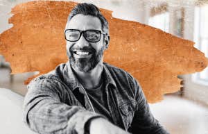 Happy man leaning over couch