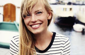 Blonde woman smiling in a striped shirt 