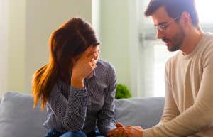 man comforting woman he cheated on