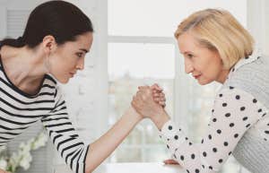 Wife and mother-in-law having an arm-wrestling match