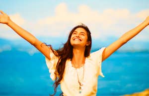 happy woman with arms outstretched