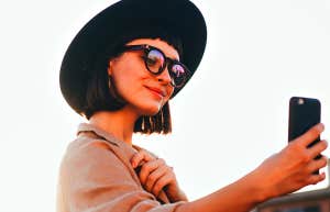 girl taking selfie with phone