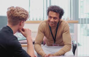 Teacher talking to student in an office