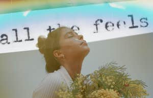 Woman holding flowers, looking up