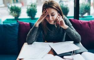 woman stressed with work papers