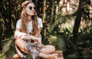 5 Toxic Myths That Kill Happiness Woman sitting cross legged in nature reflecting