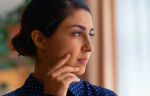 pensive woman looking out the window