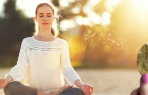 woman meditating with bay leaves