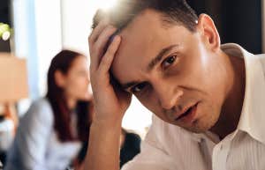 abusive husband with wife behind him going through divorce