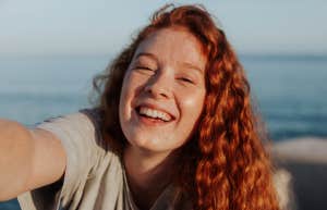 Red-haired young woman laughing freely
