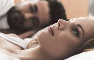 5 Things I Loathe About My Marriage woman looking miserable in bed next to husband