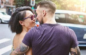 man kissing woman