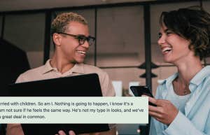 Two coworkers laughing together in office