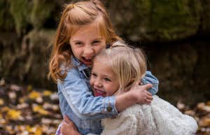 two little girls laughing and hugging each other