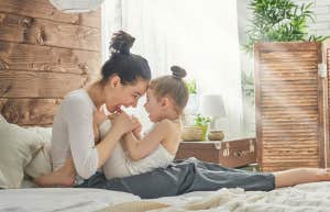 mom playing with young daughter