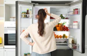 woman looking in fridge for food