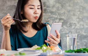 woman eyeing phone suspiciously
