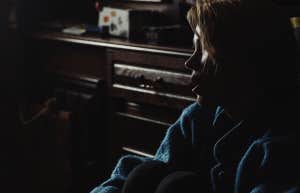 sad emotional woman alone in dark room