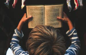little boy reading book