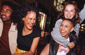 People Who Attract Positive, Uplifting Friends Do These 10 Things Differently group of friends walking together laughing