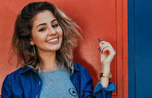 13 Personality Traits Of The Most Successful People smiling woman in blue