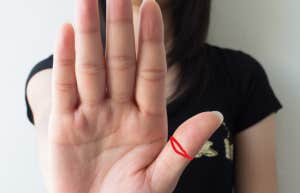 woman holding her hand up