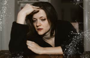 Woman sitting at dining a table completely devastated 