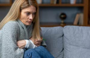 Woman on couch with blanket