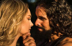 man pulling woman's face close